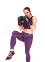 Woman in action boxing in exercise outfits