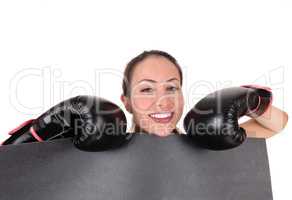 Woman with boxing gloves looking smiling