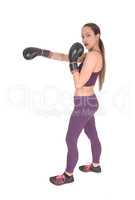 Slim woman in workout outfit boxing
