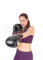 Slim woman punching with boxing cloves