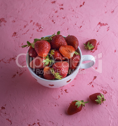 fresh red strawberry in a white ceramic mug