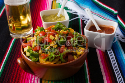 Nachos salad hot sauces and beer