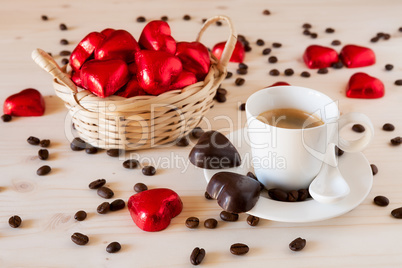 Red chocolate hearts in a small basket and an espresso coffee