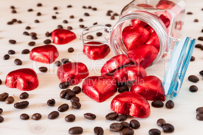 Red hearts in a glass jar and coffee beans