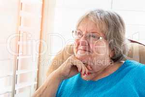 Content Senior Woman Gazing Out of Her Window