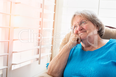 Content Senior Woman Gazing Out of Her Window
