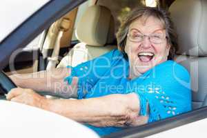 Happy Senior Woman Driving New Car