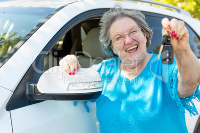 Happy Senior Woman With New Car and Keys