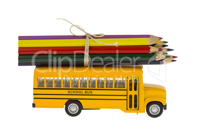 Yellow School bus and pencil in education isolated on white background