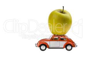 Green Yellow apple on the Beetle car model. Isolated on white background