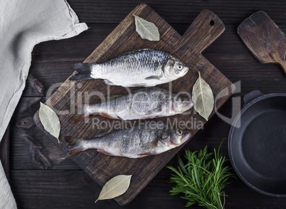 river fish crucian and perch on a brown wooden board