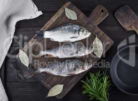 river fish crucian and perch on a brown wooden board