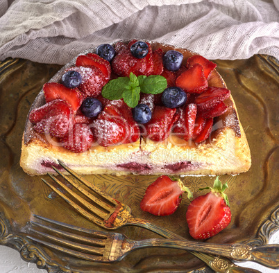 cheesecake made of cottage cheese and fresh strawberries on a pl