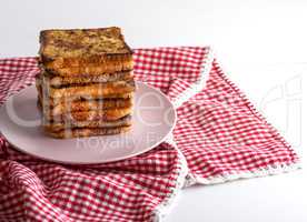 fried French toast on a ceramic pink plate