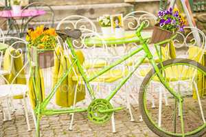 bicycle with flowers at a street cafe