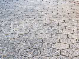 Street of hexagonal concrete blocks, badly preserved.