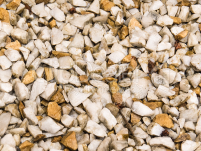 Wet floor of white pebbles, and light brown.