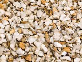 Wet floor of white pebbles, and light brown.