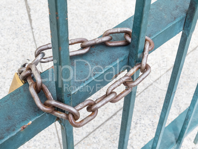 Rusty padlock and chain, on blue grid.