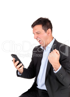 Business man screaming at his cellphone