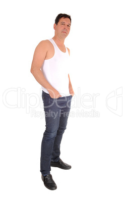 Relaxed man standing in profile in jeans