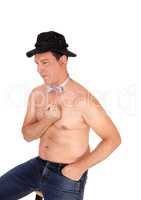 Shirtless man with a black hat an bowtie