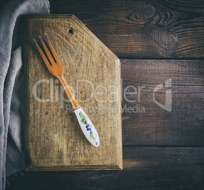 vintage wooden fork on a kitchen cutting board