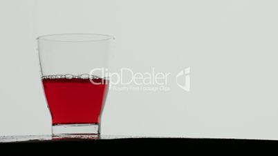 Red berry juice poured in glass