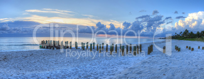 Sunset over Old pier at the ocean on Naples Beach