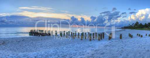 Sunset over Old pier at the ocean on Naples Beach