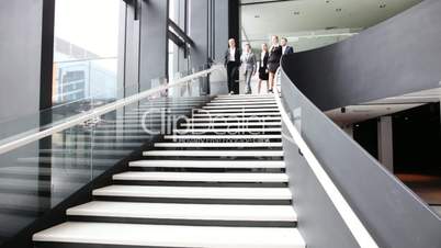 Group of business people walking at stairs