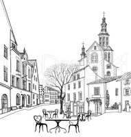 Street cafe in old city. Cityscape: houses, buildings, tower, tree