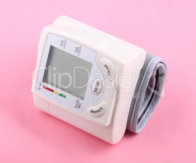 Automatic Wrist Digital blood pressure monitor on pink backgroun