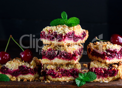 stack of square slices of a pie with a cherry