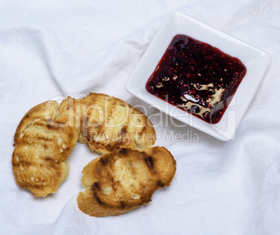 fried pieces of bread and raspberry jam