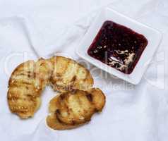 fried pieces of bread and raspberry jam