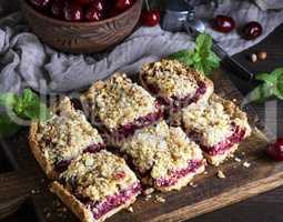 square pieces of cake crumble on brown wooden board