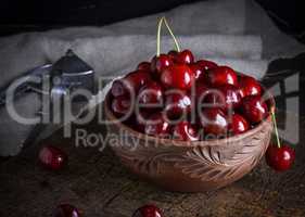 fresh cherry in a brown ceramic bowl