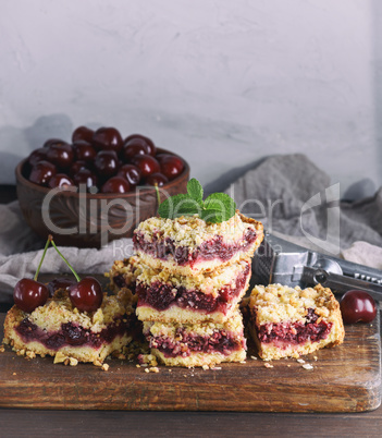 square slice of crumble pie on a brown wooden board