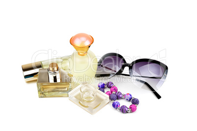 Perfume bottles, sunglasses and bracelet isolated on white backg