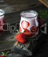 milkshake of fresh strawberries in a glass jar