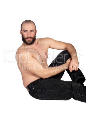 Shirtless man sitting on the floor relaxing