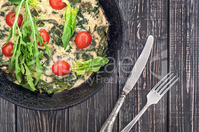 Fritatta in pan with fork and knife