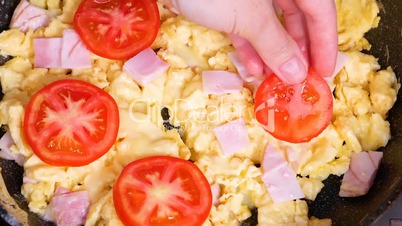 Fresh tomatoes on omelette in slow motion