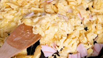 Cooking omelette with cheese and ham