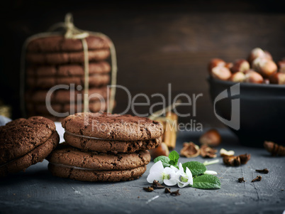 stack of round chocolate cookies with cream