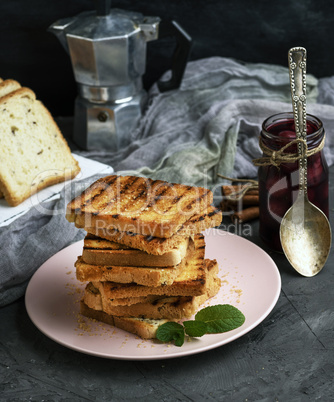 fried French toast on a ceramic pink plate