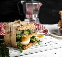 sandwich of French toast and lettuce leaves and boiled egg