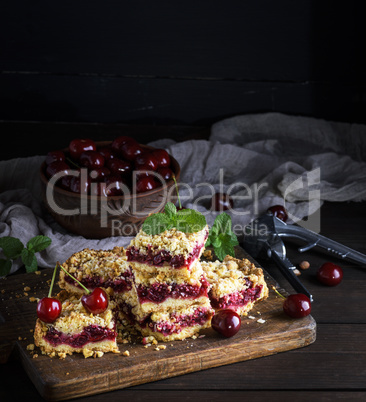 baked cake with cherry and ceramic bowl with fresh berries