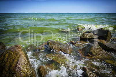 View of the Black Sea with large stones on a summer sunny day